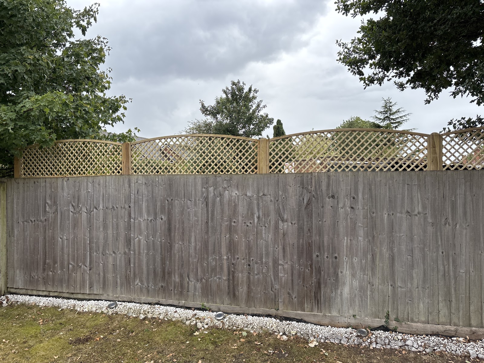 An old timber fence given a new lease of life with fresh framed trellis toppers along the top